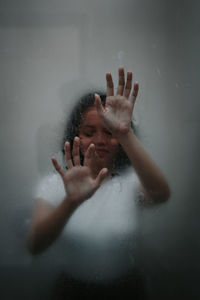 Portrait of woman hands in glass