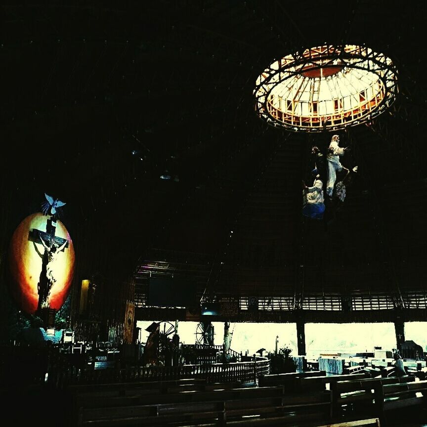 LOW ANGLE VIEW OF PEOPLE IN ILLUMINATED BUILDING