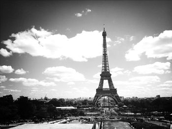 Eiffel tower against cloudy sky