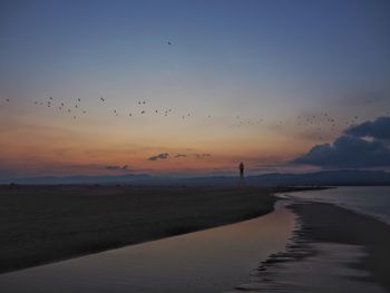 Scenic view of beach against sky during sunset