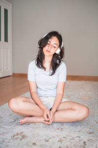 Young woman sitting on floor