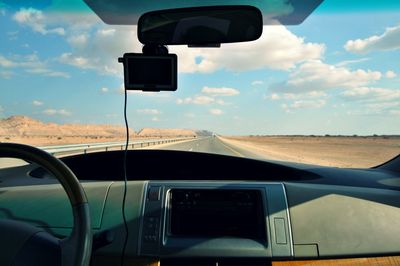 Close-up of car on road against sky