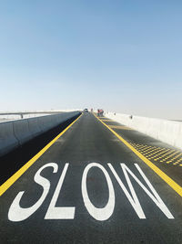 Road sign against sky