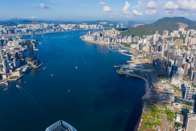 High angle view of townscape by sea against sky