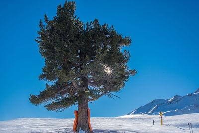 Scenic view of snow covered mountains against clear blue sky