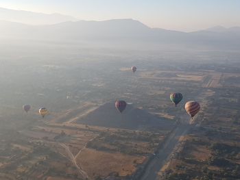 High angle view of hot air balloons flying in sky