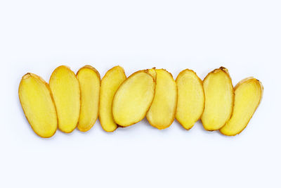 Directly above shot of yellow slices on white background
