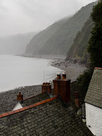 High angle view of buildings by sea against sky