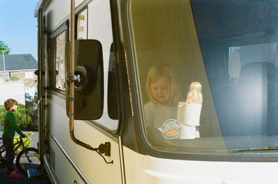 Portrait of girl seen through glass window