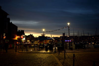 Illuminated city buildings against sky