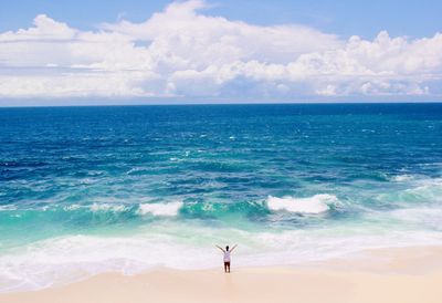 Aerial view of man standing on beach against sky