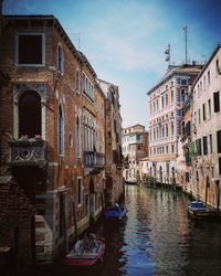 Boats in canal with buildings in background