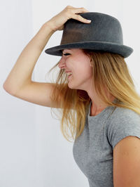 Portrait of smiling young woman against white background