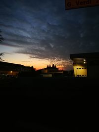 Silhouette buildings against sky at night