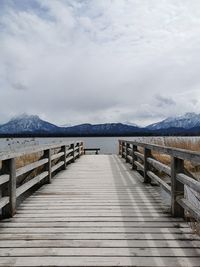 Pier over lake against sky