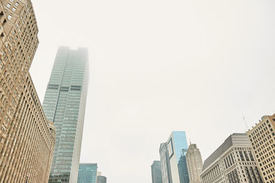 Low angle view of skyscrapers against clear sky