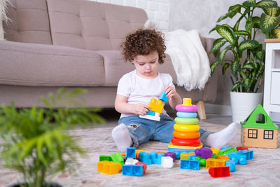 Cute girl playing with toy blocks