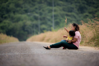 Woman sitting on road