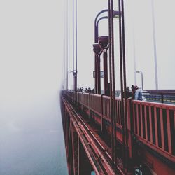 Man on bridge against sky