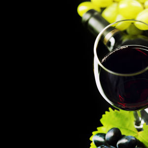 Close-up of wine glass against black background