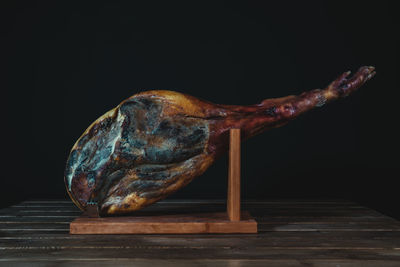 Close-up of bird perching on table