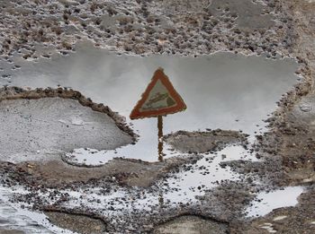 Road sign by water