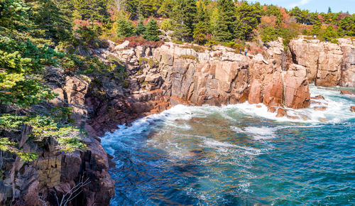 Scenic view of sea by cliff