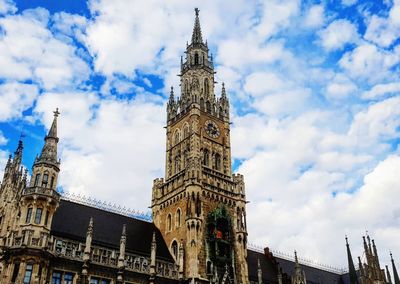 Low angle view of clock tower against sky in city