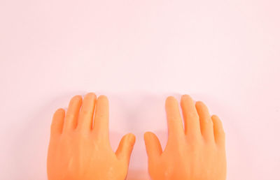 Close-up of hands against white background