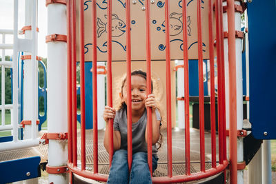 Mixed race family having fun at the kids park 