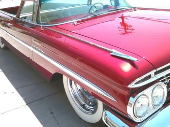 Close-up of red car on road