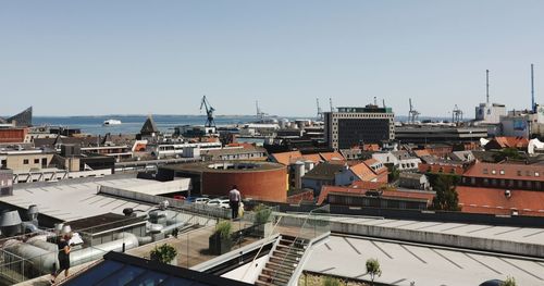 High angle view of buildings in city against clear sky