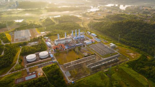 Aerial view of a gas turbine power plant station during sunrise.