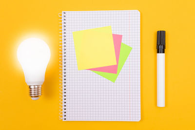 Directly above shot of yellow paper on table