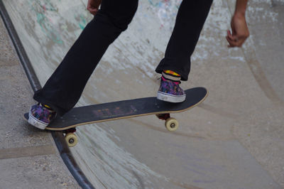 Low section of man skateboarding on skateboard