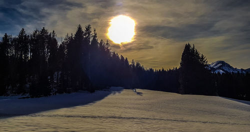 Scenic view of snowcapped mountains against sky during sunset