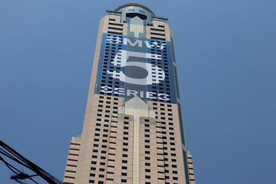 Low angle view of buildings against clear blue sky