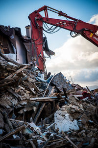 Low angle view of abandoned construction site against sky