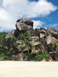 Scenic view of rock formation and trees against sky