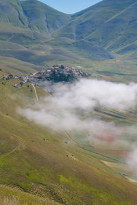 Wonderful view of castelluccio di norcia village with fog at early morning in umbria