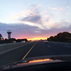 Cars on road at sunset