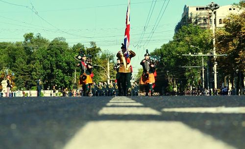 Rear view of people sitting on road