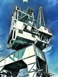 Low angle view of crane against sky