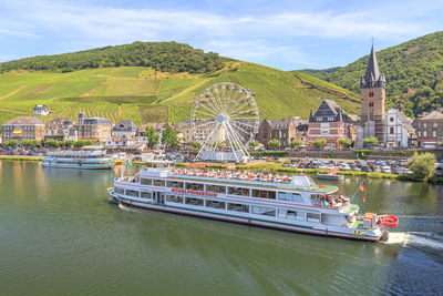 Boats in river with city in background