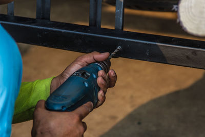 Close-up of hand drilling in metal