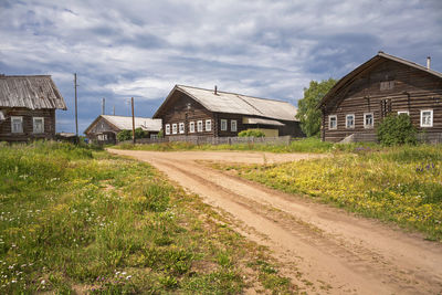 Houses on field against sky