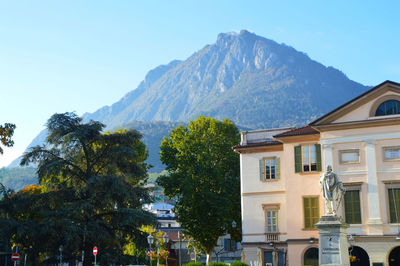 Low angle view of trees and mountain against sky