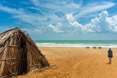 Panoramic view of people on beach against sky