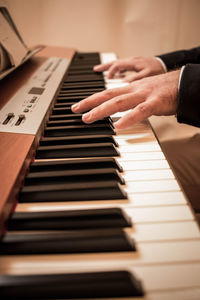 Cropped hand playing piano