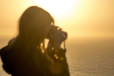 Silhouette of woman at sunset